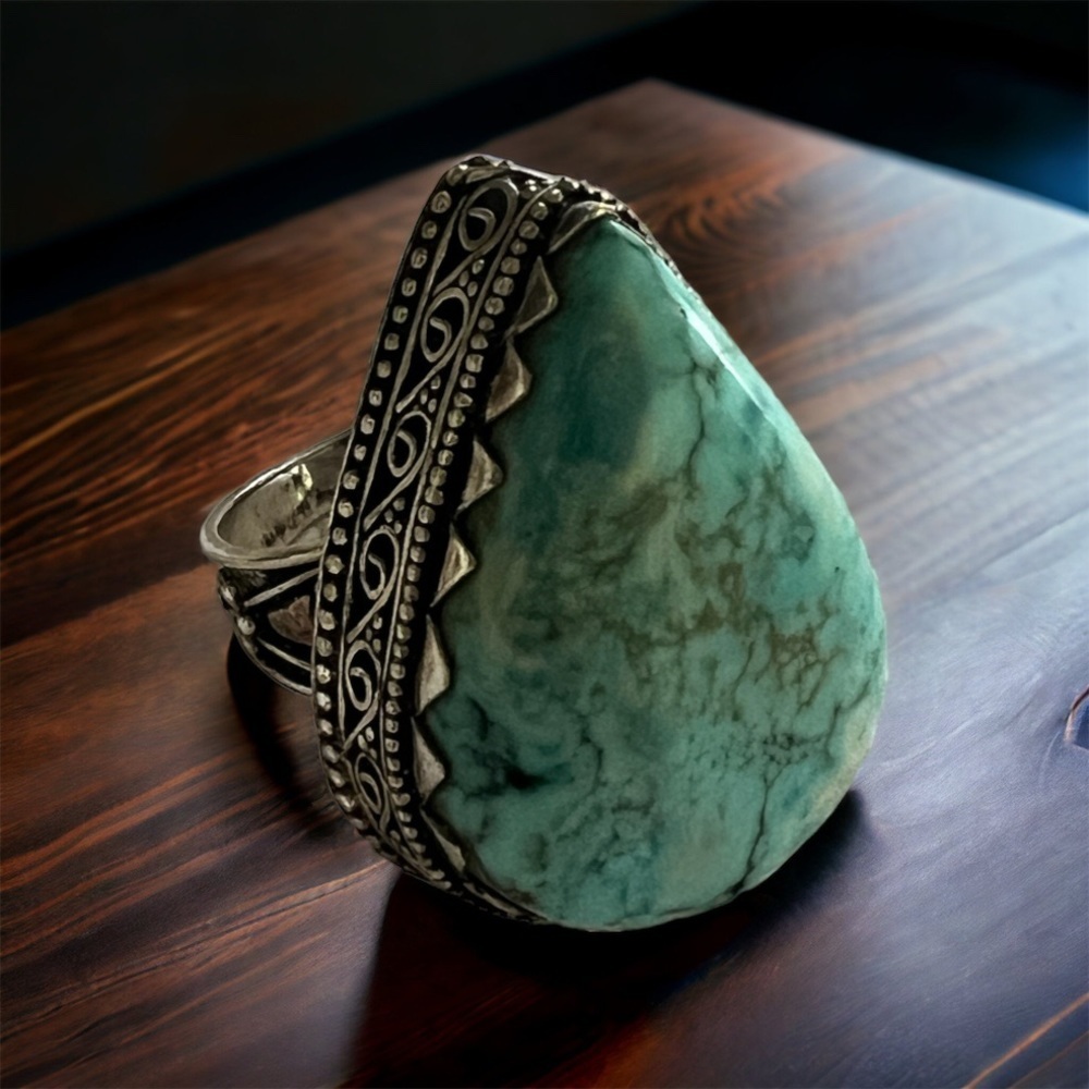 Synthetic Turquoise stone in burnished silver ring. Size 8.
